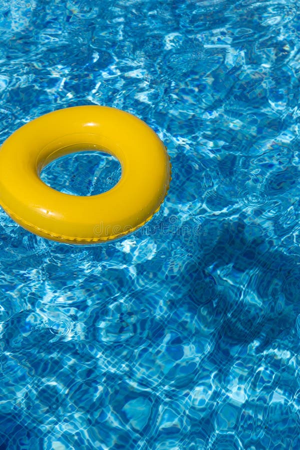 Yellow pool float, pool ring in cool blue refreshi stock photography