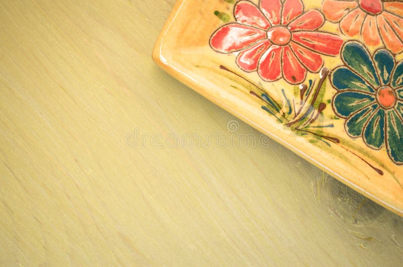 yellow porcelain tablemat on a pastel green background