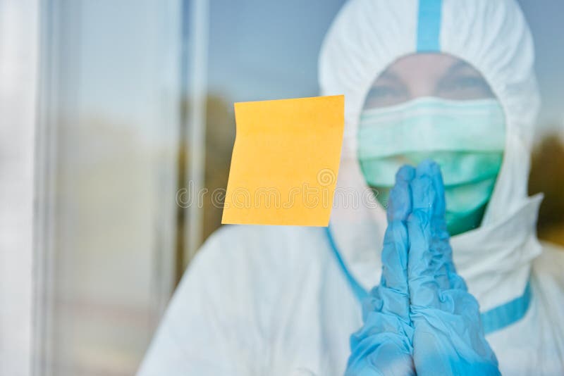 Yellow post-it note on door or window of clinic with doctor