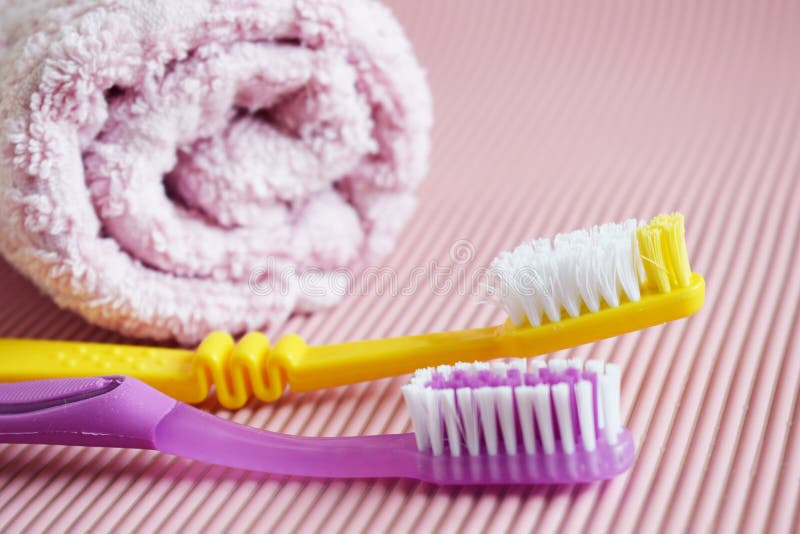 Yellow and purple toothbrush stock image