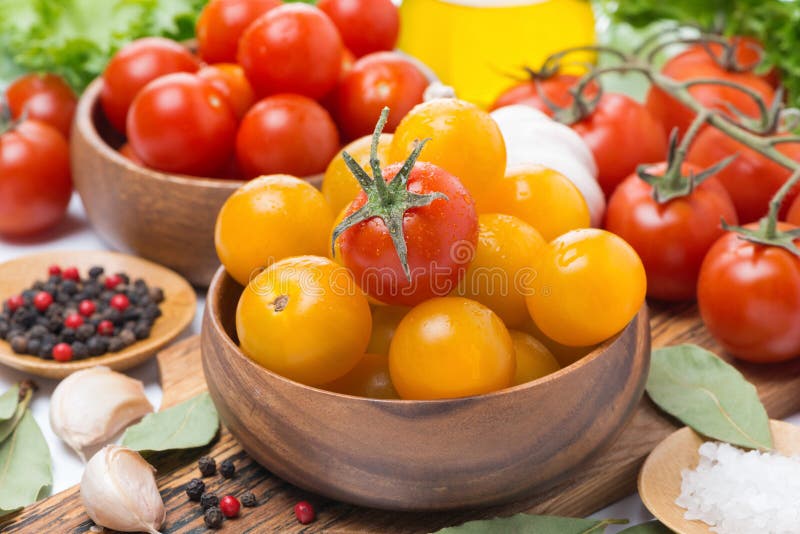 Yellow and red cherry tomatoes in wooden bowls, horizontal, close-up