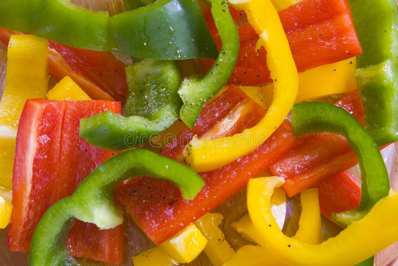 Yellow, red and green sliced peppers.