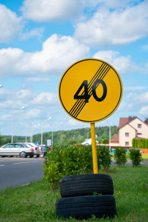 Yellow Road Sign Fixed on Tires Near the Road Stock Image Image of