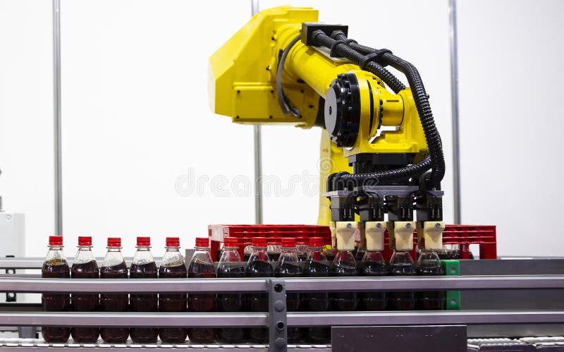 Yellow robotic arm soda bottles stock photos