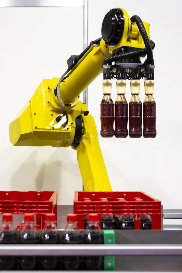 Yellow robotic arm soda bottles stock photography