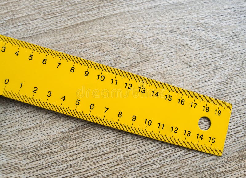 Yellow ruler on the table royalty free stock images.