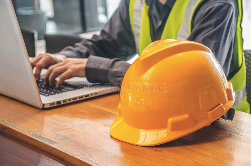 The yellow safety helmet and Business man in Construction industry is working in on computer. stock images The yellow safety helmet and Business man in Construction industry is working in on computer. stock images