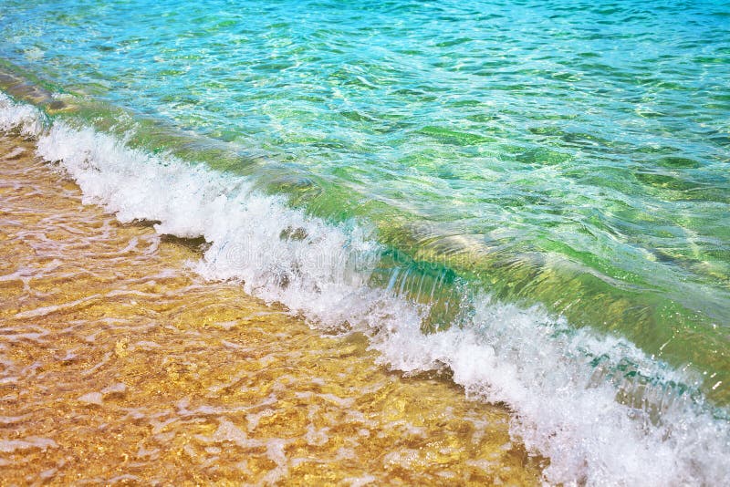 Yellow sand beach, blue sea wave and white foam landscape, turquoise transparent ocean water splash, summer holidays concept