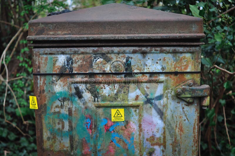 Yellow sign danger electricity on metal can outside in England . High quality photo