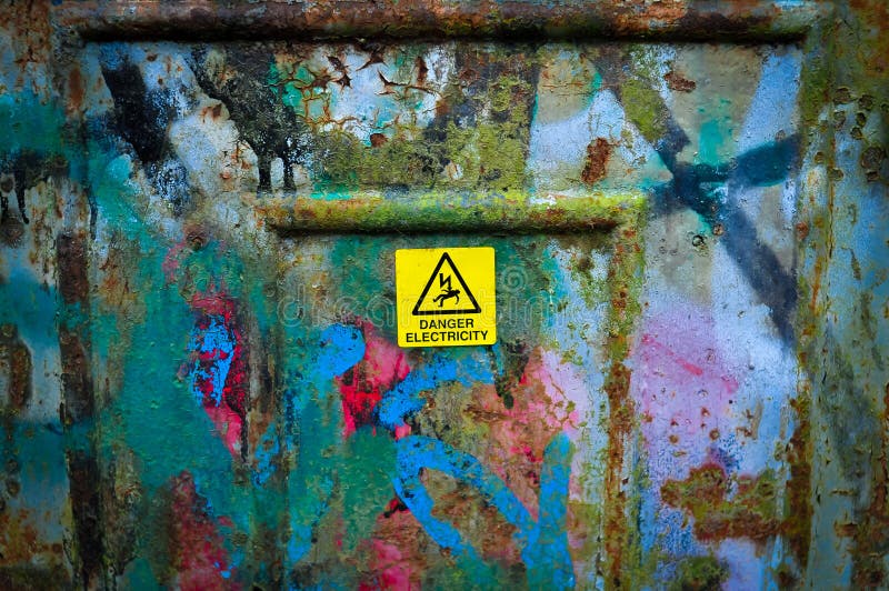 Yellow sign danger electricity on metal can outside in England . High quality photo