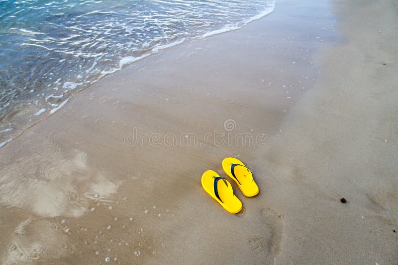 Yellow Slippers on the Sand Beach Stock Photo - Image of flops, sandals ...