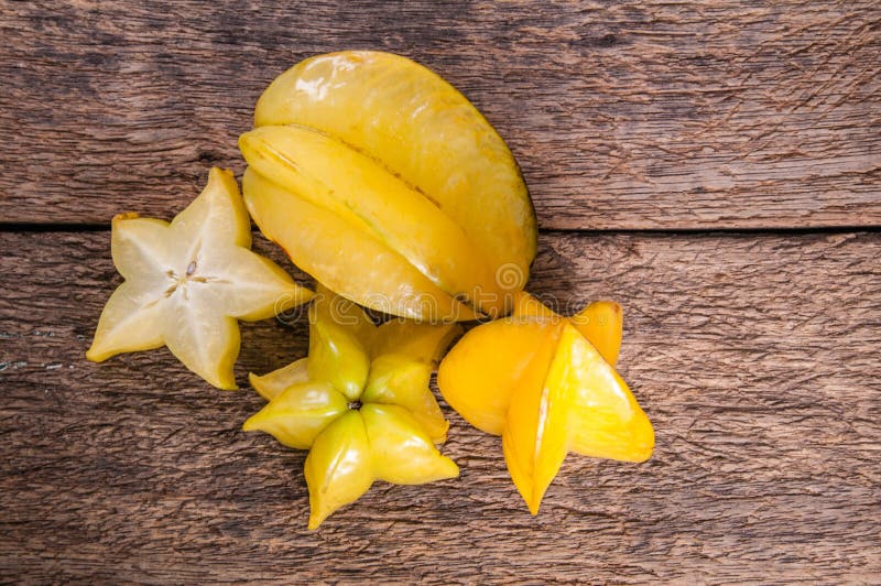 Yellow star fruit or star apple on wood background