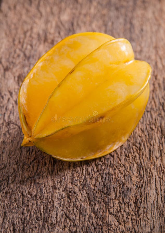 Yellow star fruit or star apple on wood background