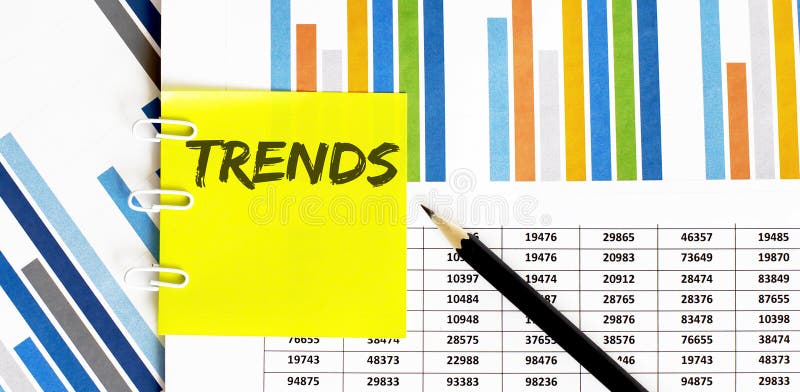 Yellow sticker with text TRENDS on the chart with pencil . It can be used as a business and financial concept