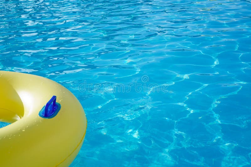 Yellow swim ring in a swimming pool with rippled water, background royalty free stock image Yellow swim ring in a swimming pool with rippled water, background royalty free stock image