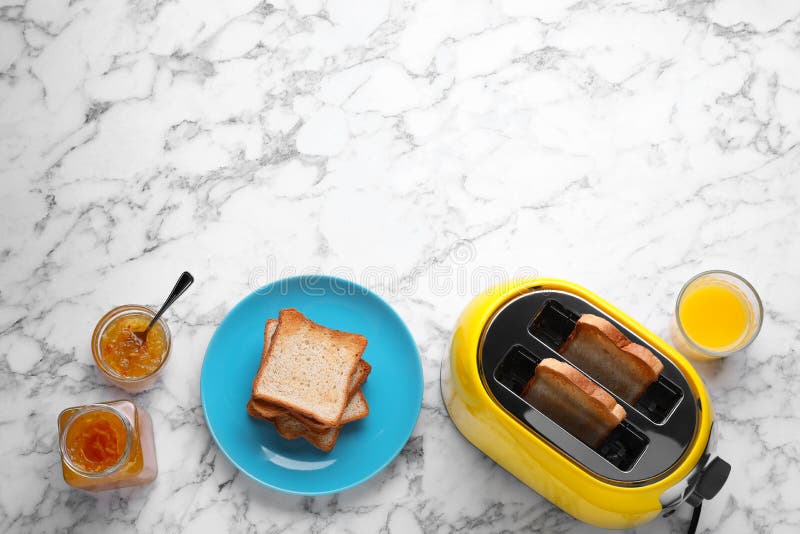 Yellow Toaster with Roasted Bread, Glass of Juice and Jam on White