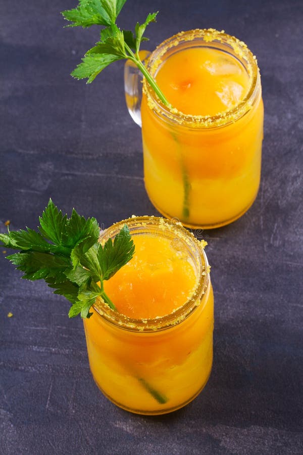 Yellow Tomato Cocktail with Celery, Spices, Salt and Ice. Stock Image