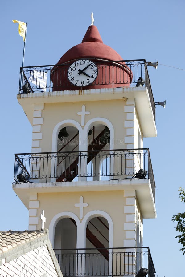 Yellow the town hall with clock in Moraitika. Corfu. Greece.