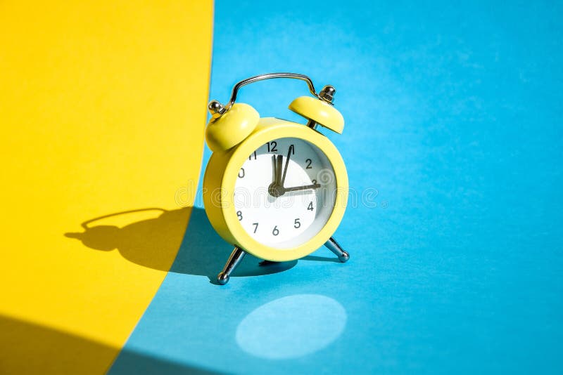 Yellow Vintage Alarm Clock On A Blue And Yellow Background With