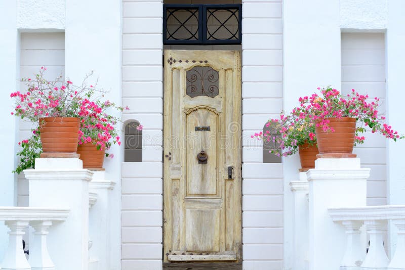 Yellow vintage wooden door on white wall