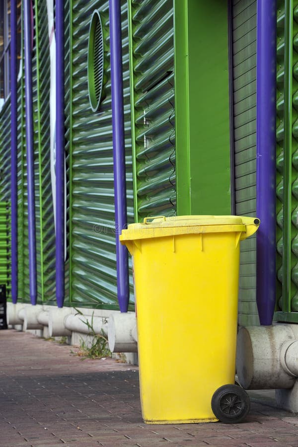 Yellow wheeled garbage can stock photo. Image of environment 34568946