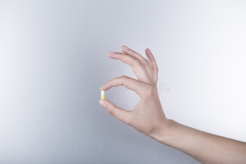 Yellow and White Capsule in a Female Hand Stock Image Image of pills