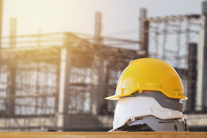 yellow with white safety helmet on table in construction