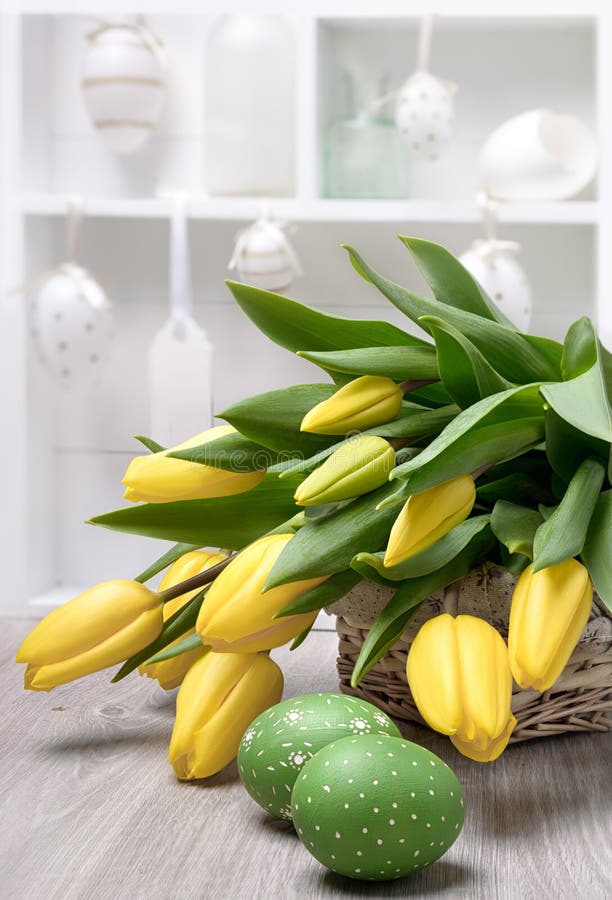 Yelow tulips, Easter eggs and decorations in a shadowcase
