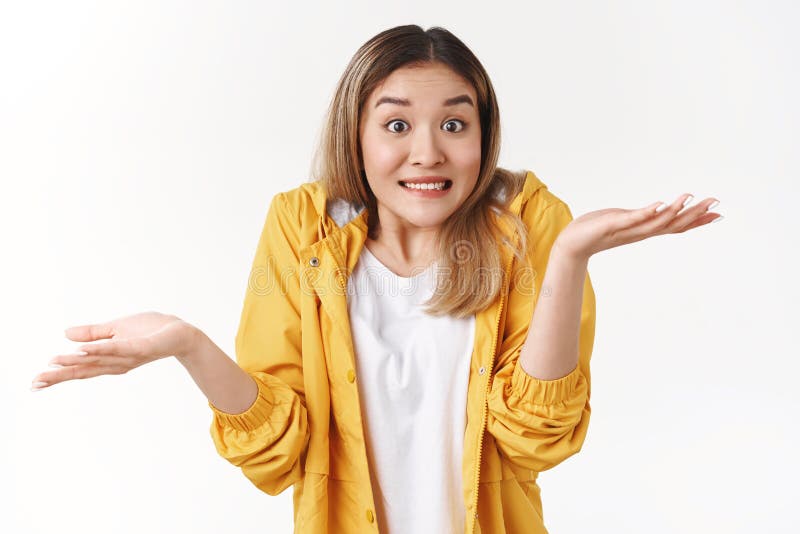 Yikes sorry not knew. Awkward cheerful blond asian woman shrugging hands spread sideways unaware questioned perplexed royalty free stock photos Yikes sorry not knew. Awkward cheerful blond asian woman shrugging hands spread sideways unaware questioned perplexed royalty free stock photos