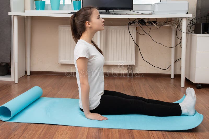 Yoga Classes at Home. Young Woman Doing Exercises Online on the