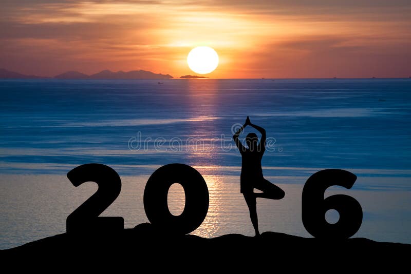 Silhouette young woman play Yoga on the sea and 2016 years while celebrating new year with sunrise. Silhouette young woman play Yoga on the sea and 2016 years while celebrating new year with sunrise
