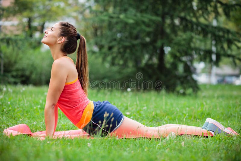 Yoga di pratica della giovane donna di misura nel parco della citt? fotografie stock Yoga di pratica della giovane donna di misura nel parco della citt? fotografie stock