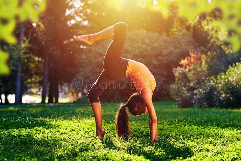 yoga Esercizio del ponte Yoga della giovane donna o dancing o allungamento di pratica in natura al parco Concetto di stile di vit fotografie stock libere da diritti yoga Esercizio del ponte Yoga della giovane donna o dancing o allungamento di pratica in natura al parco Concetto di stile di vit fotografie stock libere da diritti