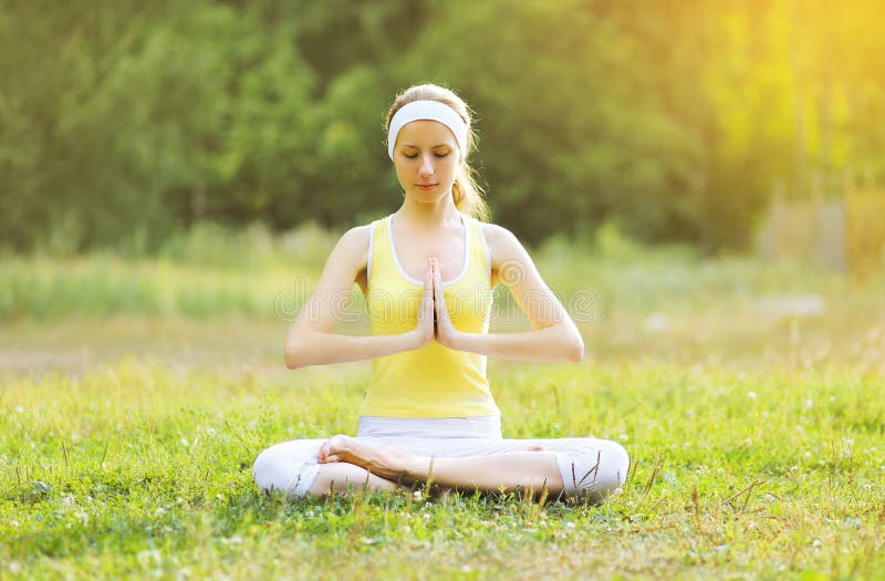 Yoga girl meditates outdoors