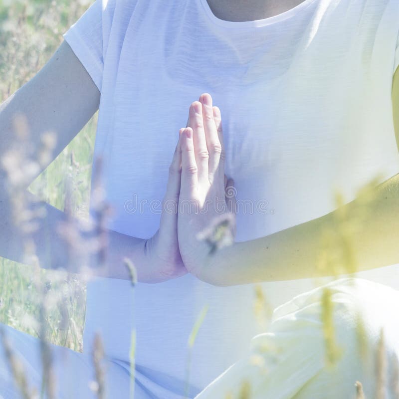 Yoga hands for meditation and mindfulness, soft toned romantic filter. Closeup of yoga hands of a young adult for relaxation, meditation, health and mindfulness royalty free stock photos