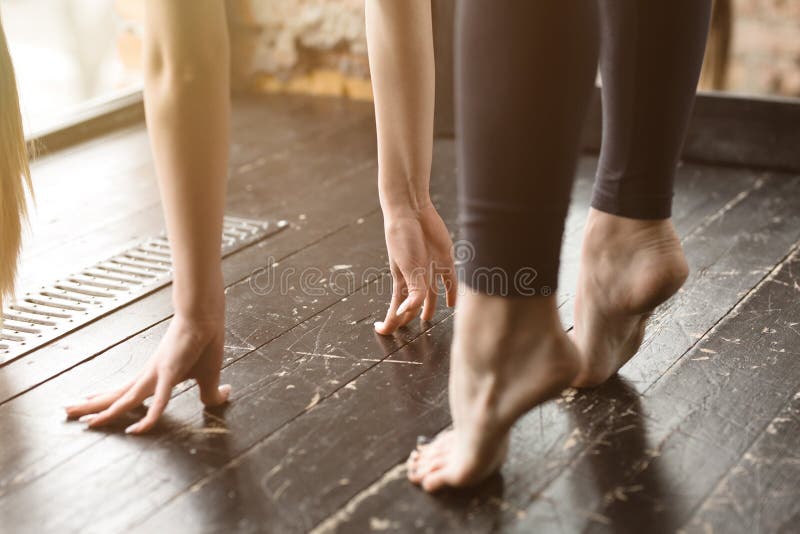 Yoga Instructor Standing On The Toes Of The Feet And Doing The Asana. A
