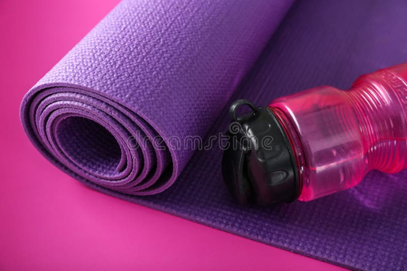 Yoga Mat And Bottle Of Water On Color Background Stock Image - Image of ...