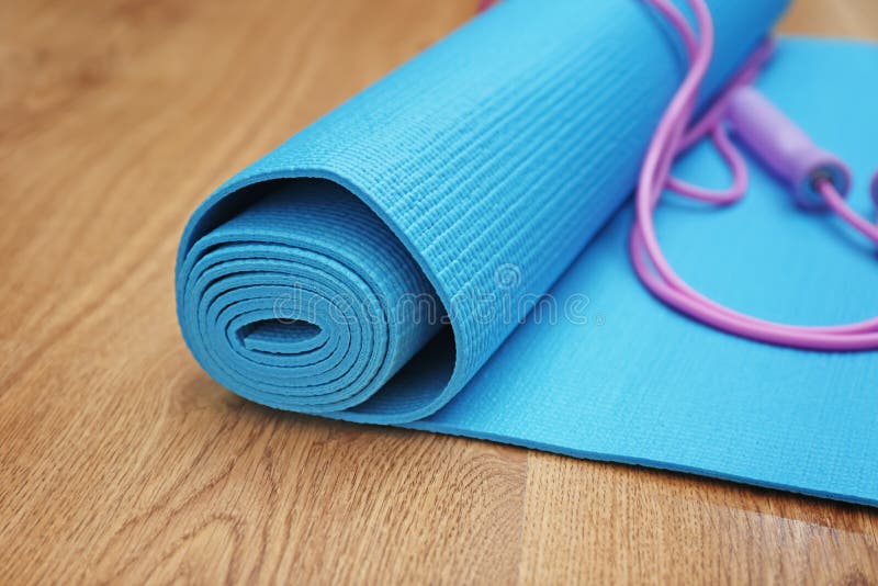 Yoga Mat with Jumping Rope on Wooden Floor Stock Photo - Image of ...