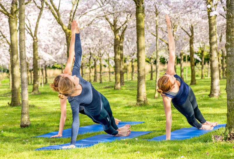 Yoga outside on the grass stock photo. Image of slim - 77659692