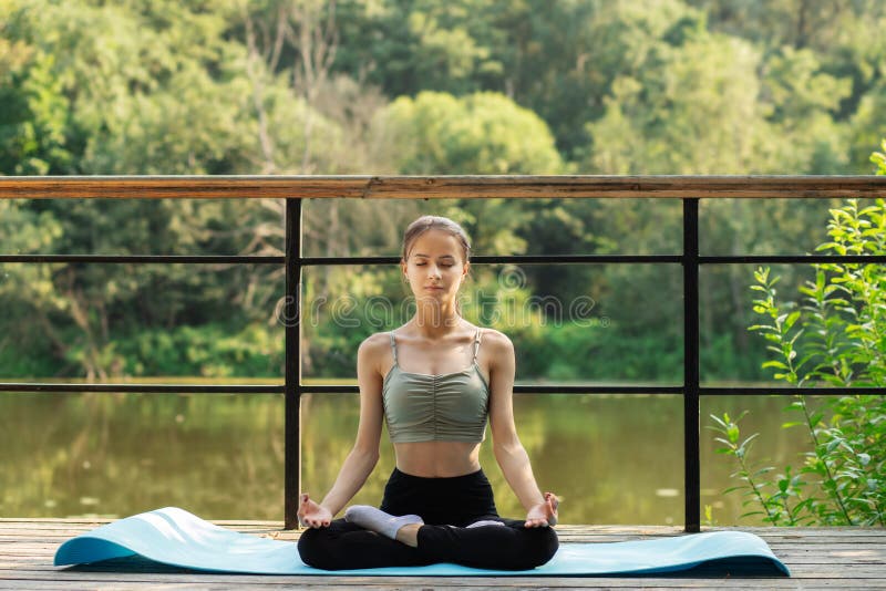 Young Indian woman practicing yoga outdoor in a park. Beautiful girl  practice basic yoga pose. Calmness and relax, female happiness. Basic Yoga  poses outdoor 17097089 Stock Photo at Vecteezy