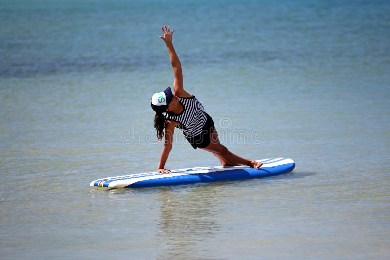 Yoga position on surfboard editorial image. Image of position - 67733085