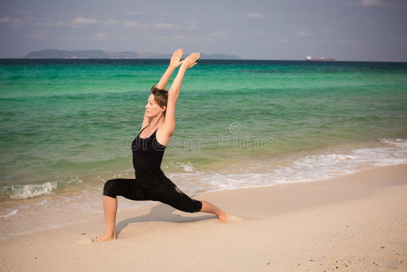 Asian Chinese Woman in Various Yoga Poses at the Beach Stock Photo