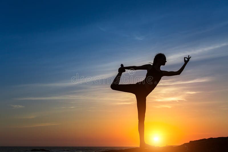 Yoga silhouette. Meditation girl on the sea during sunset.