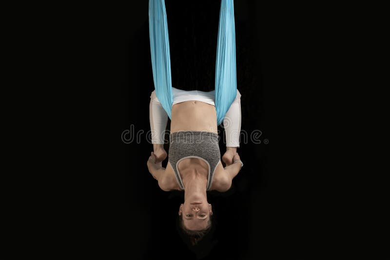 Yoga teacher in class demonstrates inverted asanas during fly yoga. Girl practices anti-gravity yoga upside down stock images