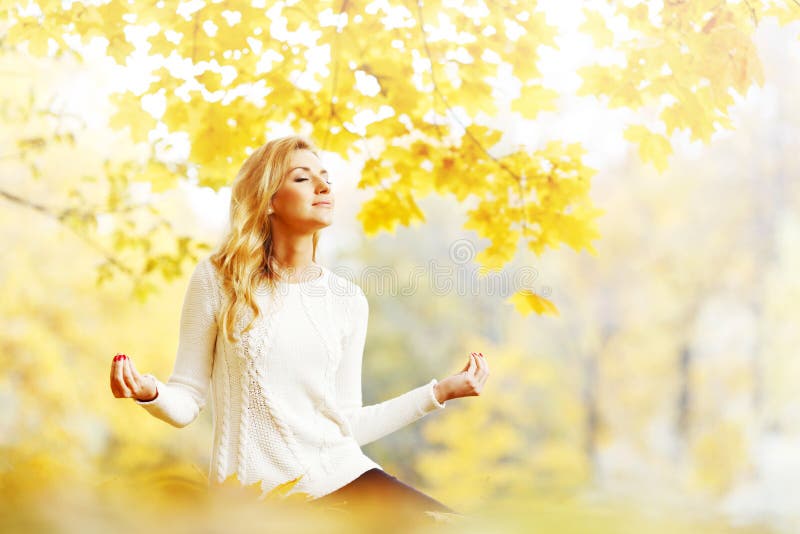 Yoga woman in autumn park