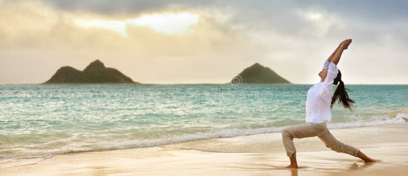 Woman Practicing Yoga Pose On The Beach At Sunrise In Kauai