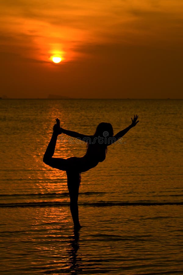 Yoga women silhouette at sunset stock photography
