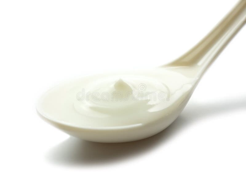 Yogurt in white spoon isolated on white background with shadow.