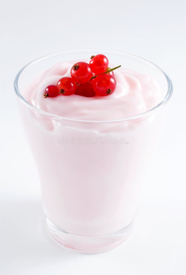 Yogurt in a glass cup toped with fresh currant.