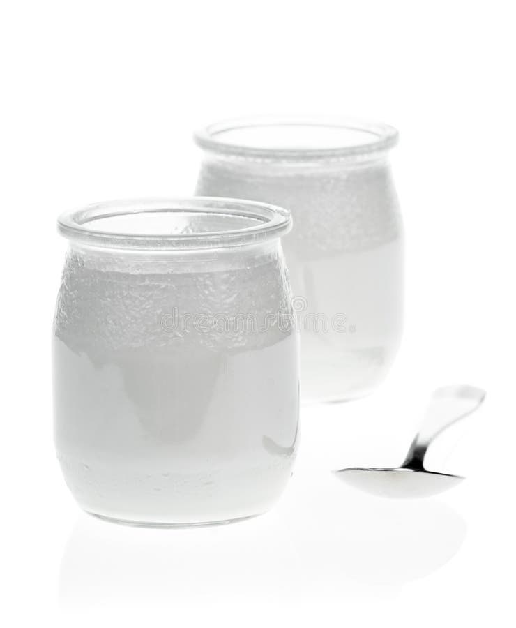 Greek Yogurt In A Glass Jars With Spoons On White Background Stock